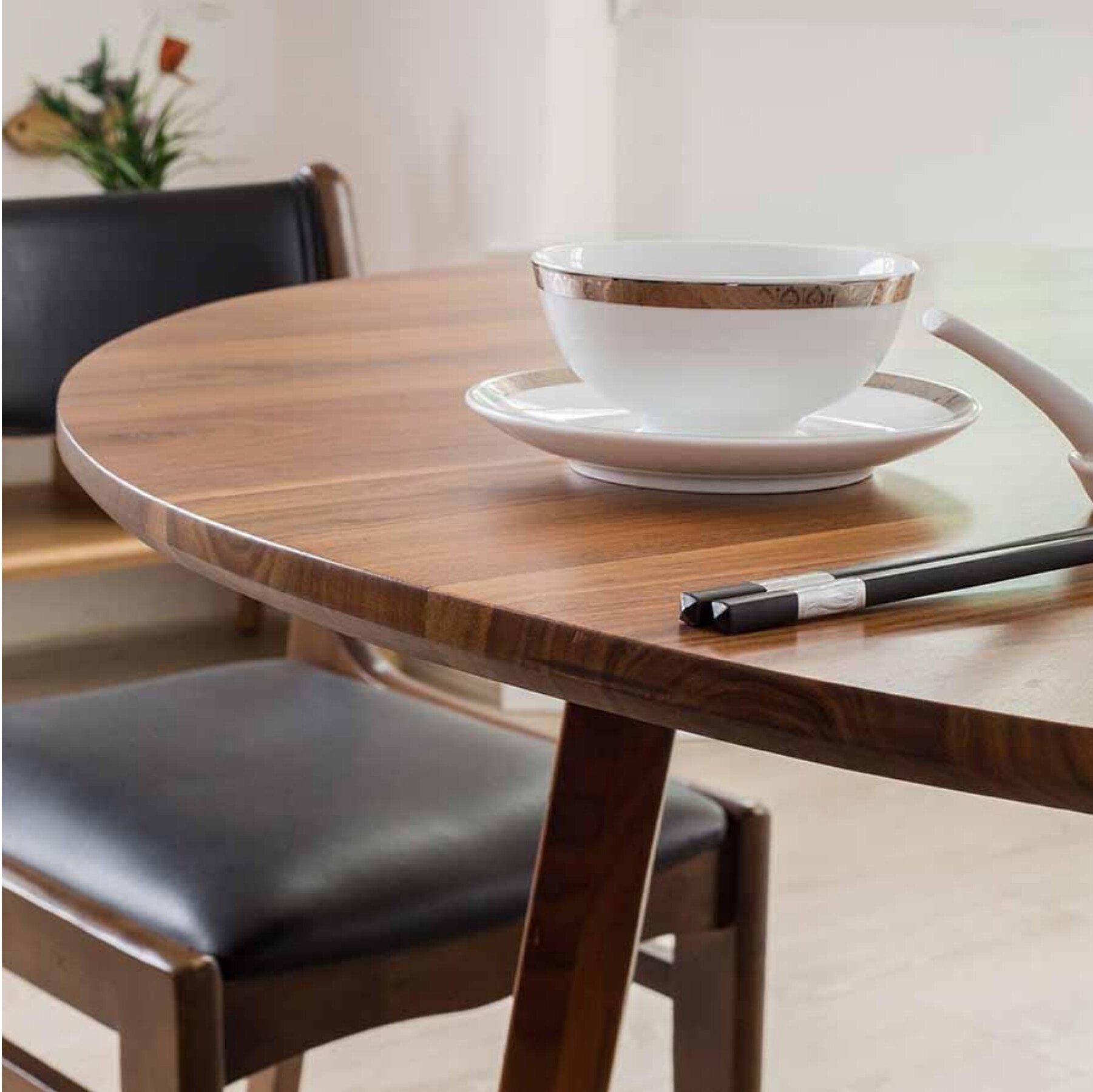 Round wooden Rond dining table with sculptural carved base — foundations of the project
